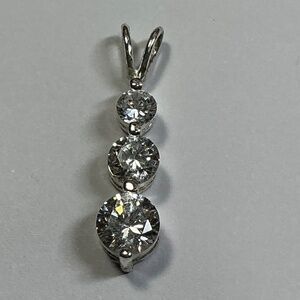 Sterling Silver cascading pendant with clear stones. 1 inch long